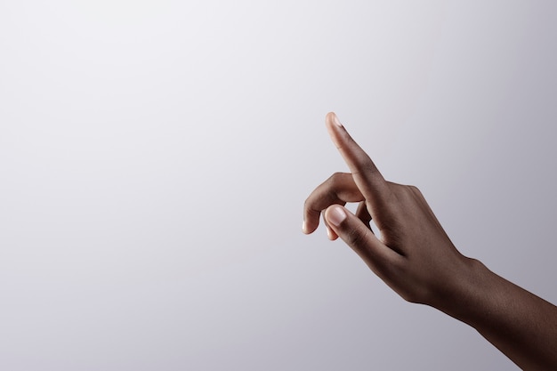 Woman's finger pointing on gray border background