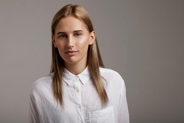 Woman's front portrait about ideal skin and straight healthy shiny hair