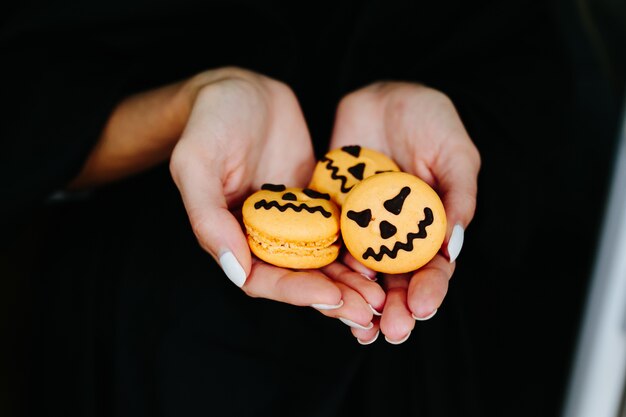 Woman's hands with pumpkin biscuits