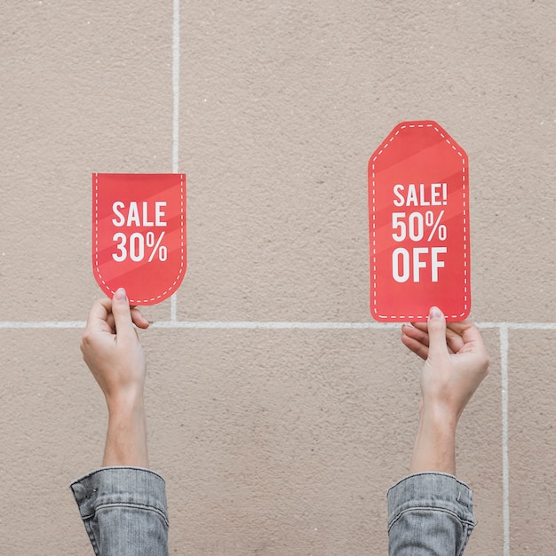 Free photo woman's hands with sale signs