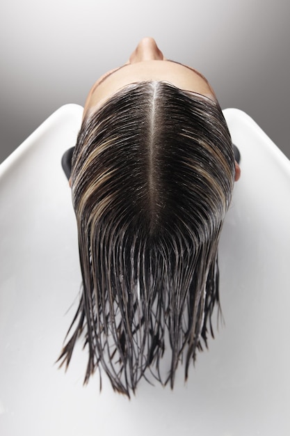 Woman's head with a mask in salon