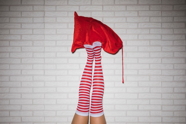 Woman's legs in stockings with red sack 