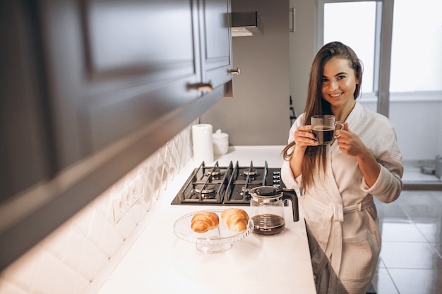 Woman's morning with coffee and croissant