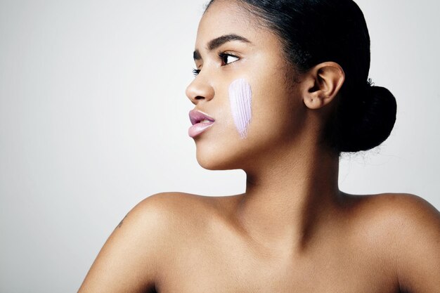 Woman's profile with a cream on a cheek