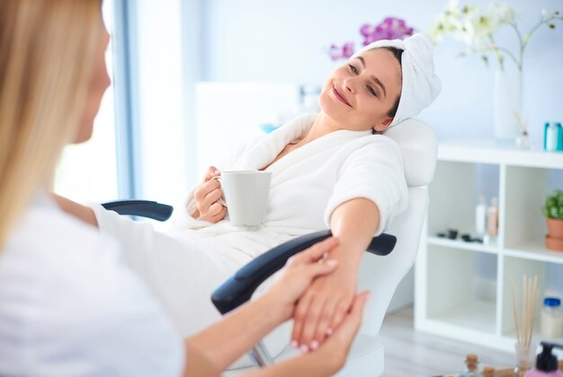 Woman at salon getting her manicure