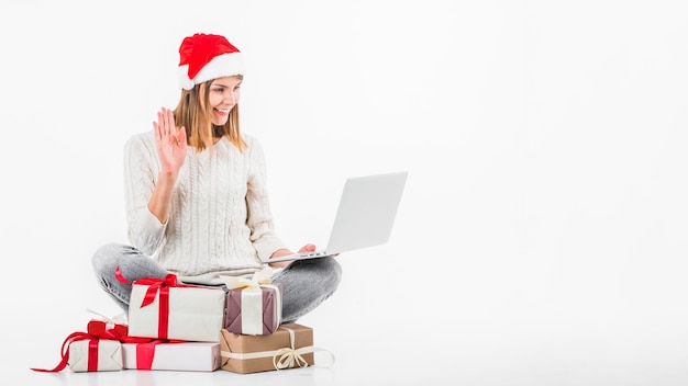 Woman in Santa hat making video call