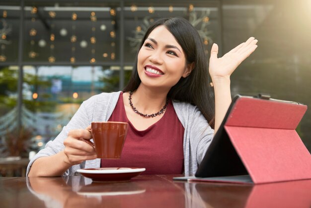 Woman saying hello at the cafe