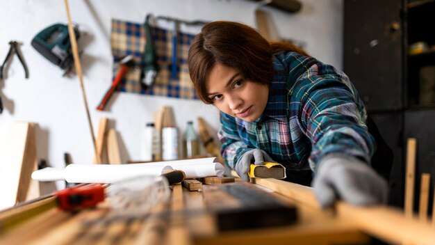 Woman scraping wood planks