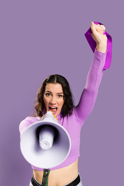 Free photo woman screaming in megaphone and raising one arm