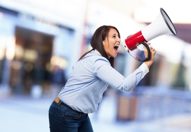 Free photo woman screaming through a megaphone