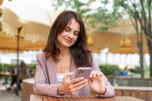 Woman scrolling on phone medium shot