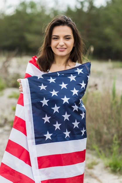 Woman at sea covered in american flag