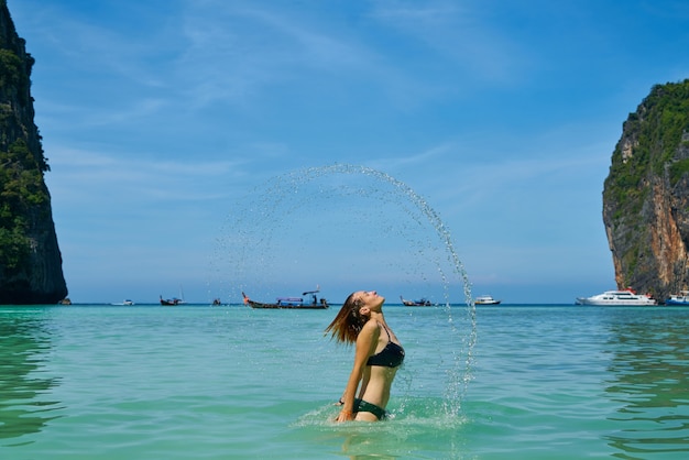 Free photo woman in sea with beautiful landscape