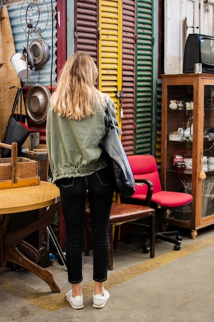 Woman searching for something to buy in an antiques market