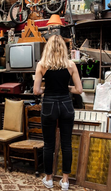 Woman searching for something to buy in an antiques market