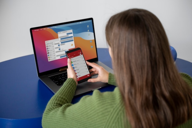 Woman searching for something on the internet using her smartphone while being at home