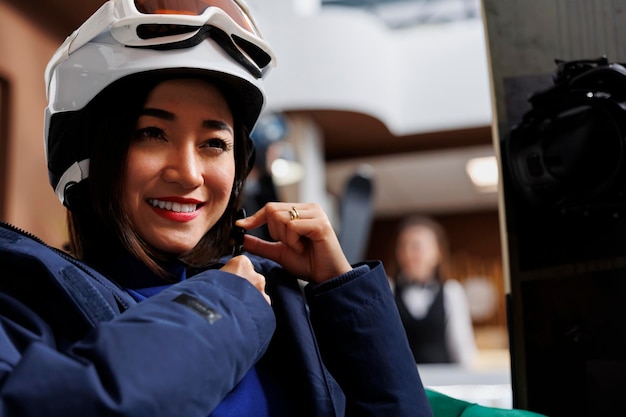 Woman secures band of snow headgear