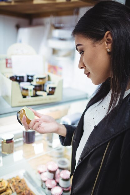 Woman selecting honey at food counter