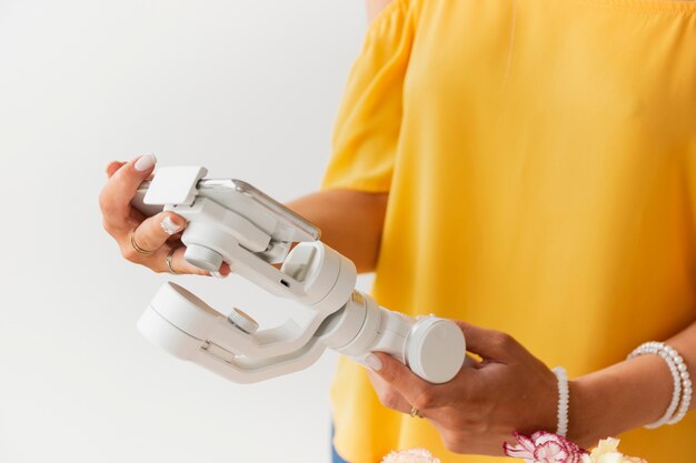 Woman setting mobile in support to film