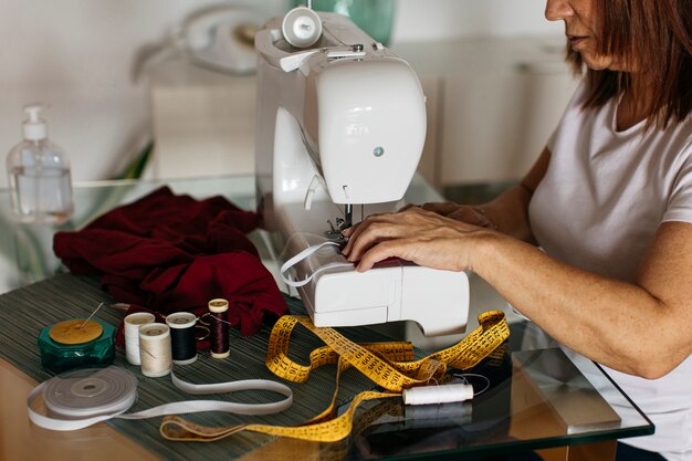 Woman sewing cloth face mask for family