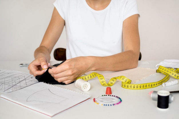 Woman sewing face mask with thread