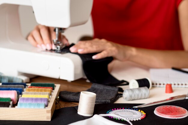 Woman sewing face mask with thread