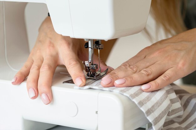 Woman sewing textile with machine