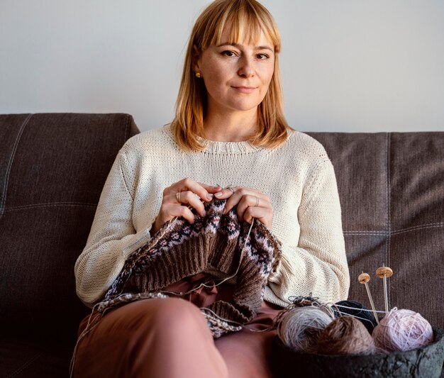 Woman sewing with different thread colors