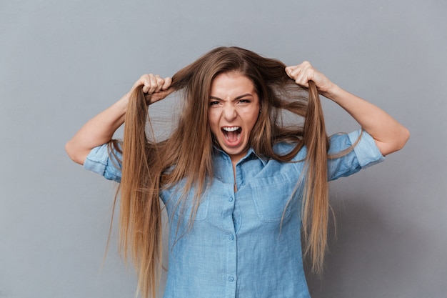 Free photo woman in shirt holding her hair