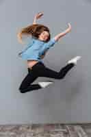 Free photo woman in shirt jumping in studio