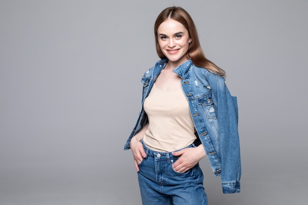 Woman in shirt posing  with crossed arms and looking at camera isolated gray wall