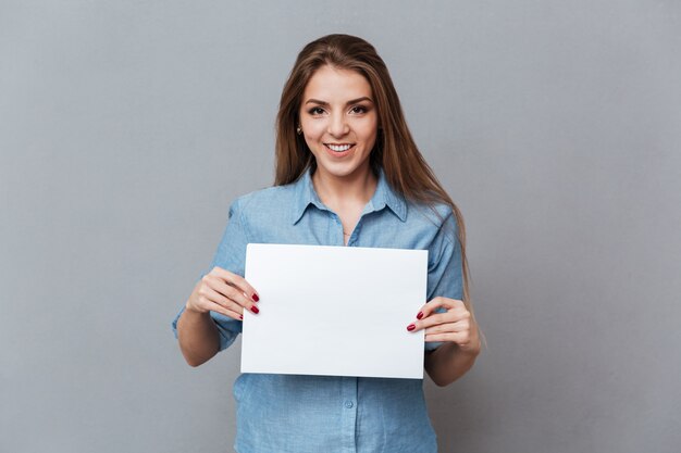 Woman in shirt showing blank board