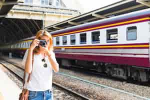 Free photo woman shooting on camera on depot