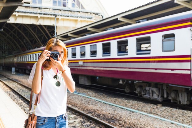 Woman shooting on camera on depot 