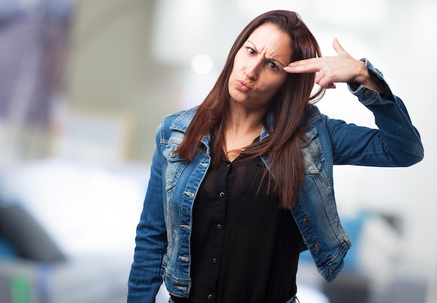 Woman shooting at the head with her fingers