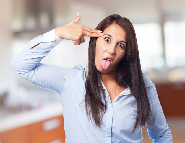 Woman shooting her head with the fingers of a hand