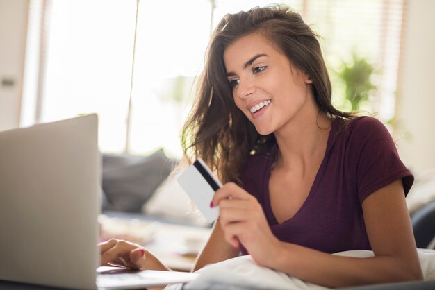 Woman shopping online with laptop. Shopping online is much more easier and faster