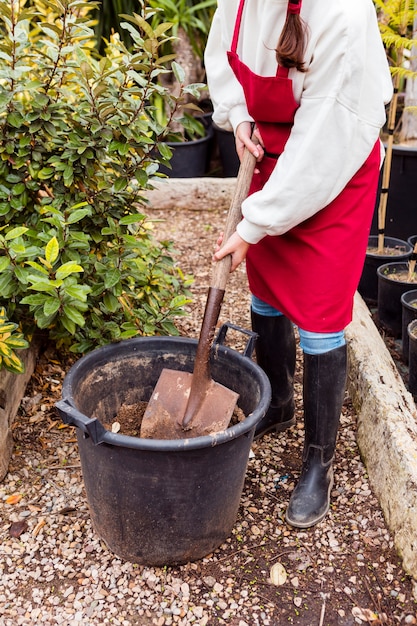 Woman shoveling in large pot