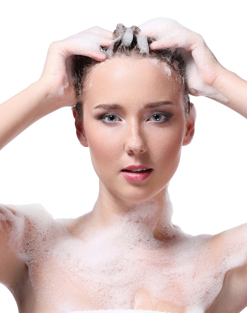 Woman showering with soap on the body and head. Hygiene and skin care concept