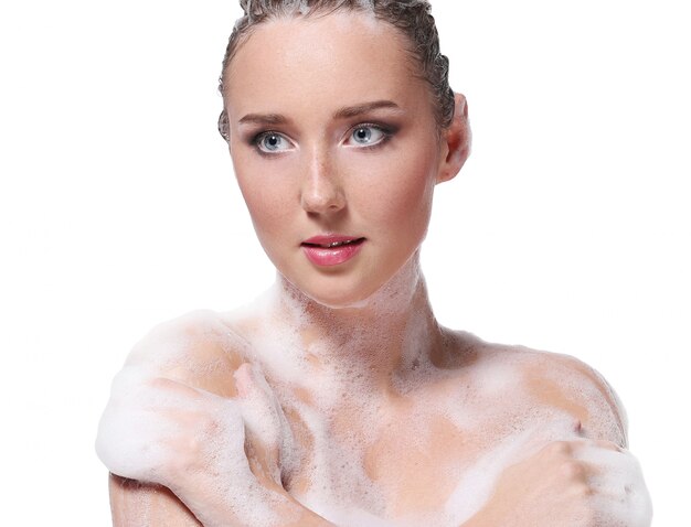 Woman showering with soap on the body and head. Hygiene and skin care concept