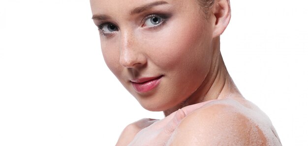 Woman showering with soap on the body and head. Hygiene and skin care concept