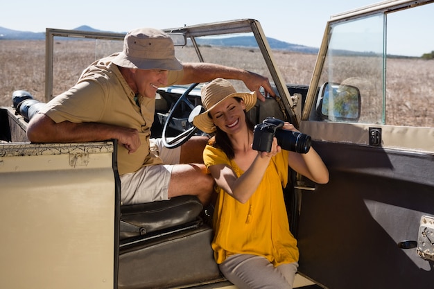 Foto gratuita donna che mostra macchina fotografica per equipaggiare in veicolo