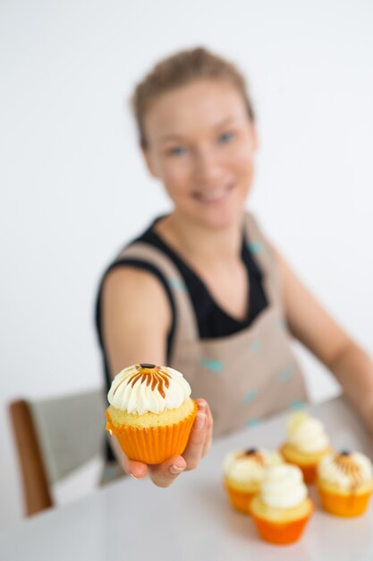 Woman showing Halloween cupcake