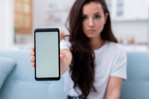 Woman showing her empty display phone