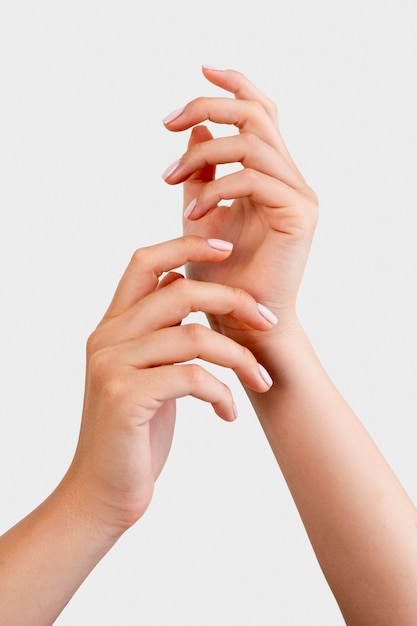 Woman showing her manicure on white background