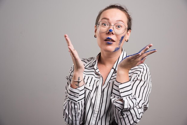 Woman showing her paints hands on gray