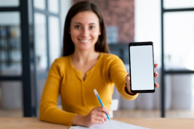 Woman showing her phone screen