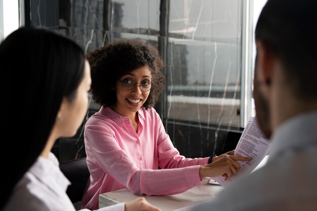 Woman showing her workmates a document