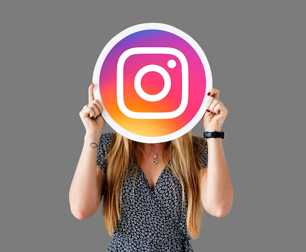 Free photo woman showing an instagram icon