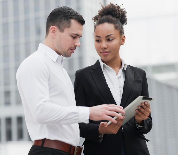 Woman showing ipad to colleague